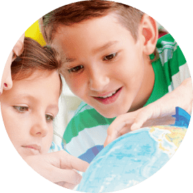 The child in kindergarten is looking at the globe